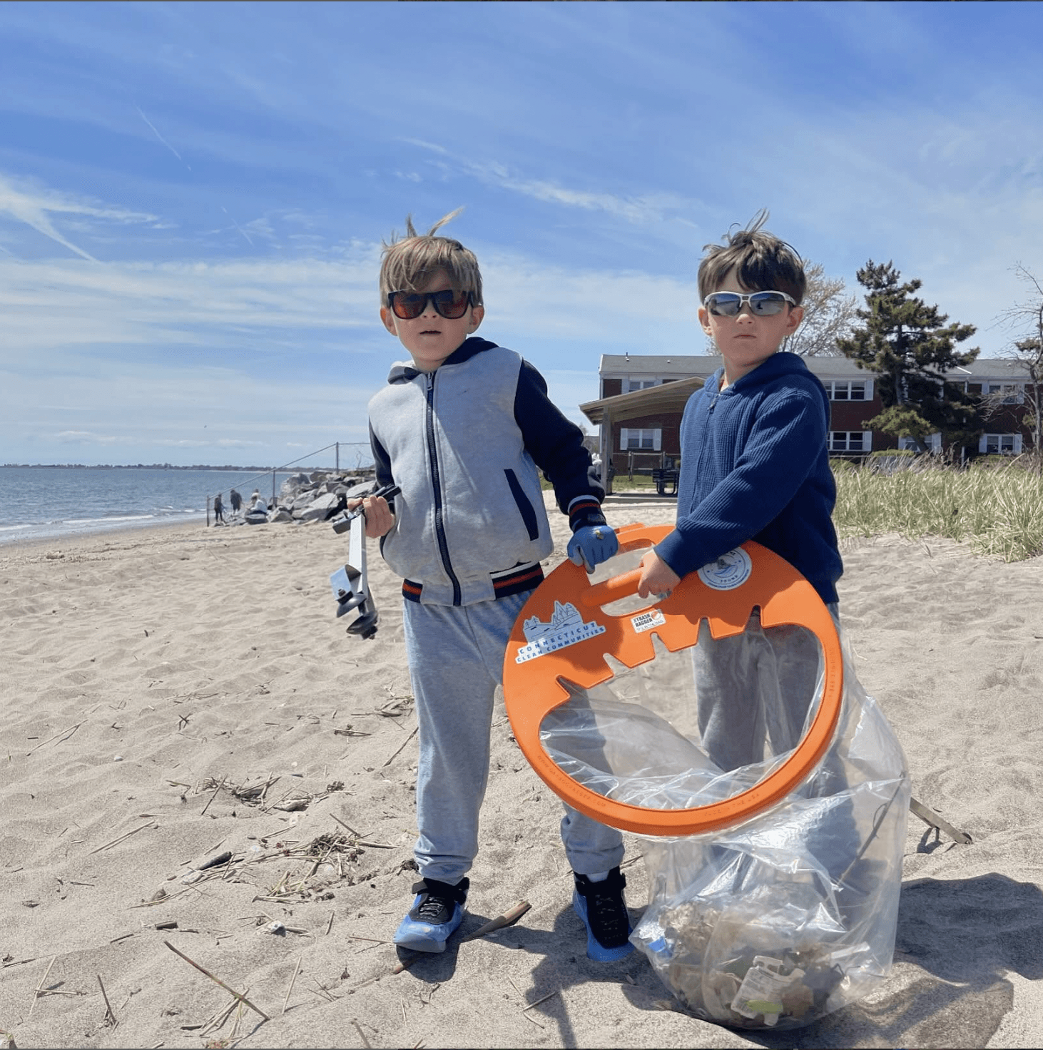 Twin brothers cleaning up the beach