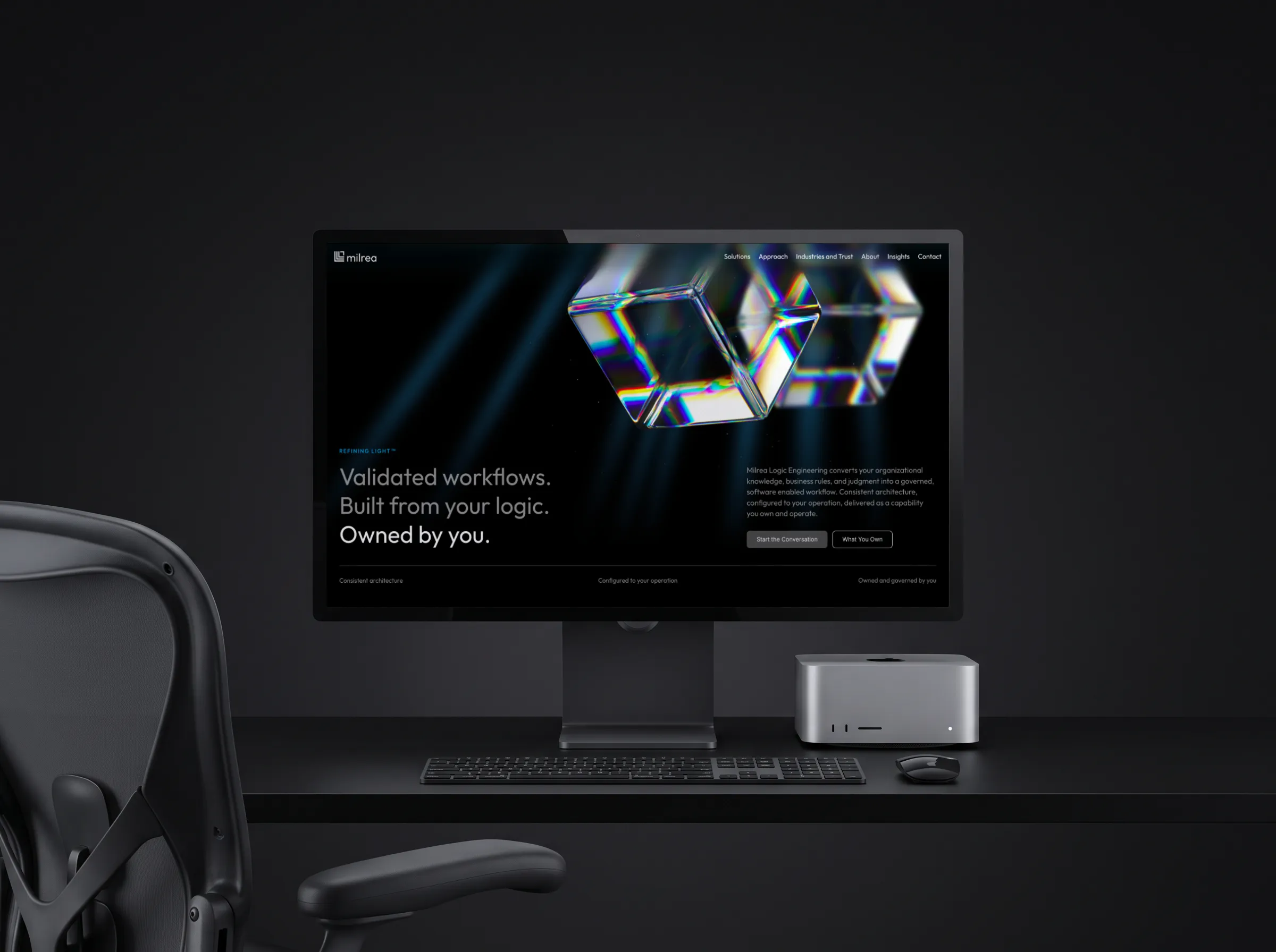 Milrea homepage with iridescent glass cubes shown on a desktop monitor.