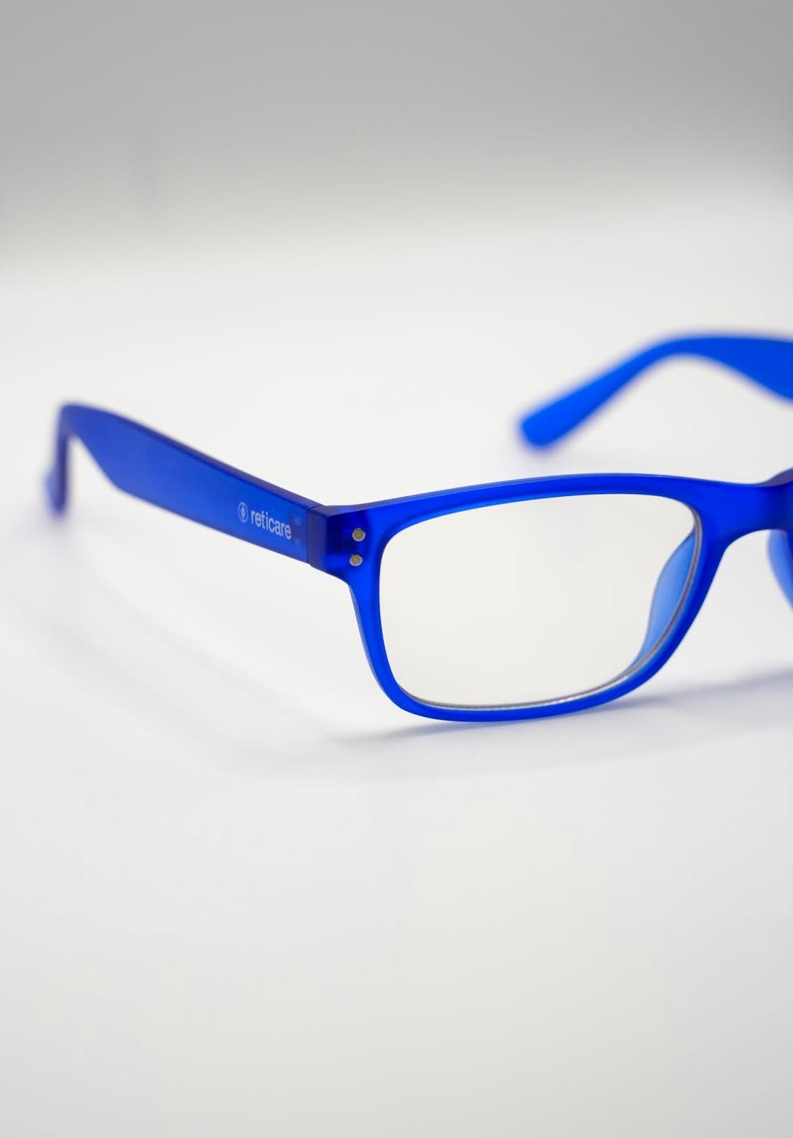 Man in a sporty jacket and light shorts walking across a football field, confidently pulling on his collar.