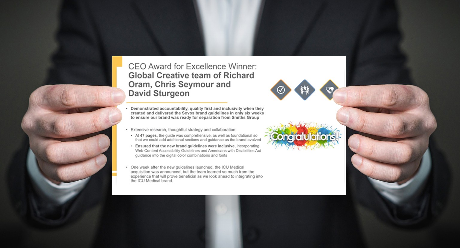 A person in a suit is holding a card with text detailing a CEO Award for Excellence.