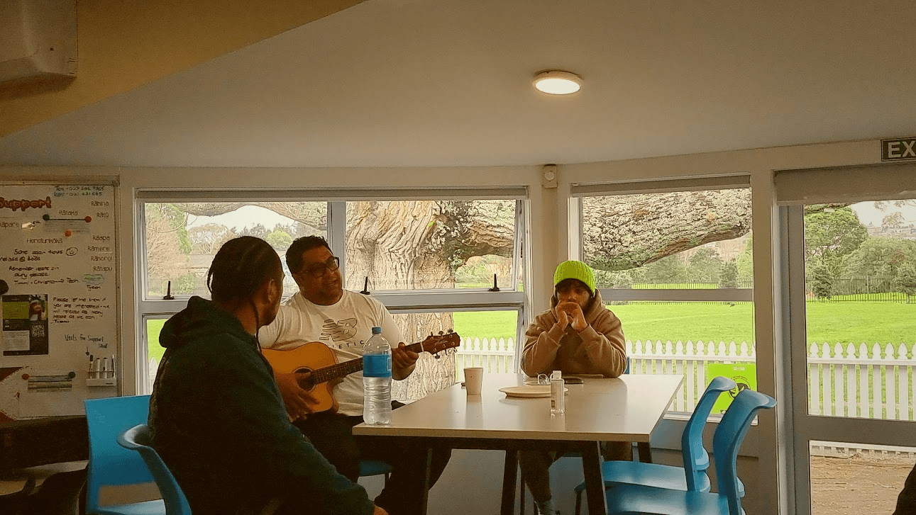 People singing and playing the guitar