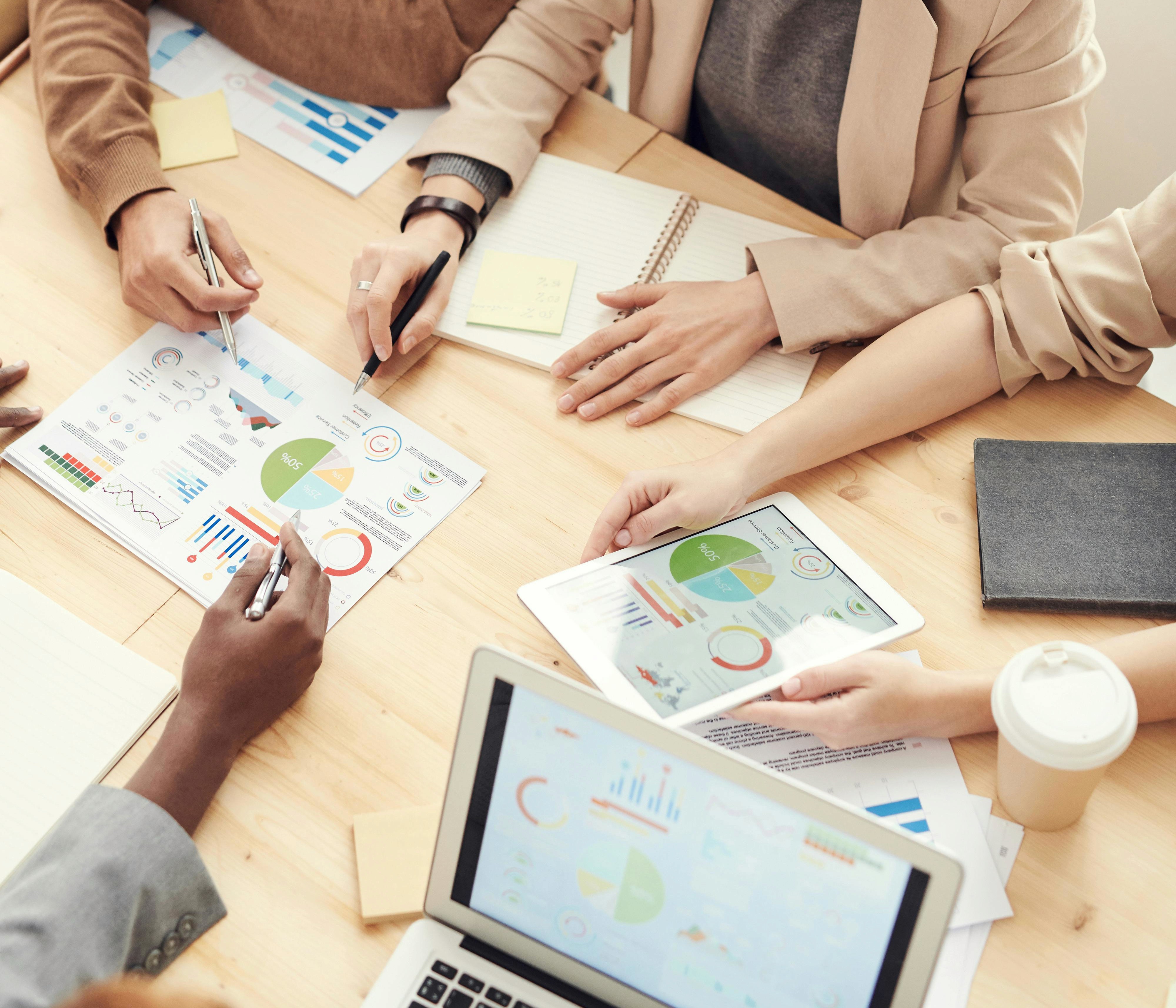 two people in a workspace working on their laptops 