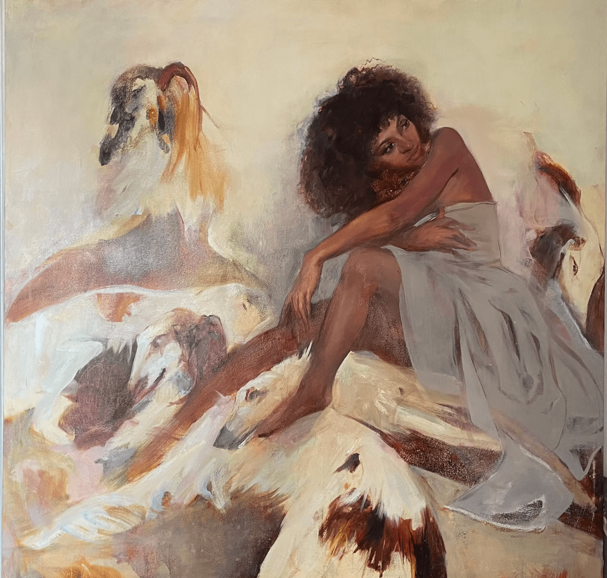 A woman with curly hair, draped in a light fabric, sits gracefully among ethereal, abstract forms resembling animals, set against a muted, textured background.