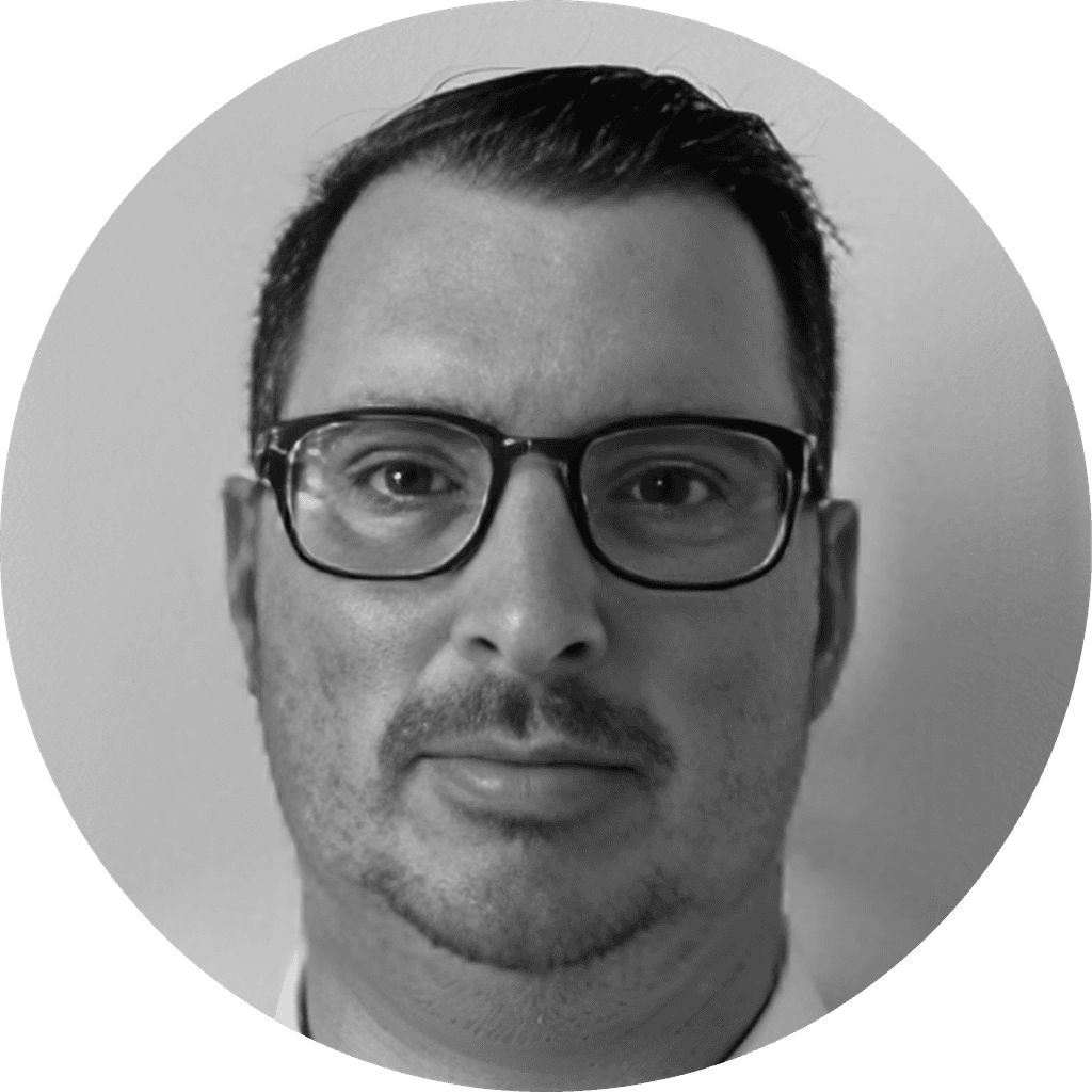 Black and white photo of Waylon Baumgardner featuring dark glasses and facial hair