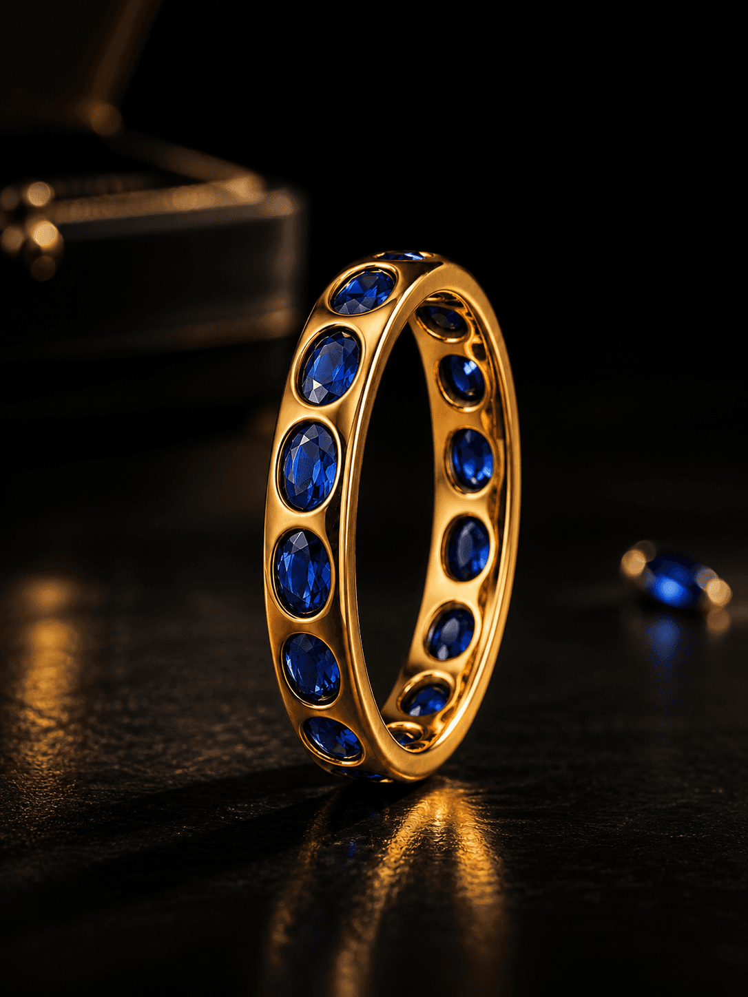 Gold eternity ring with blue sapphire stones
