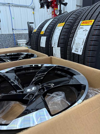 a man is working on an orange car