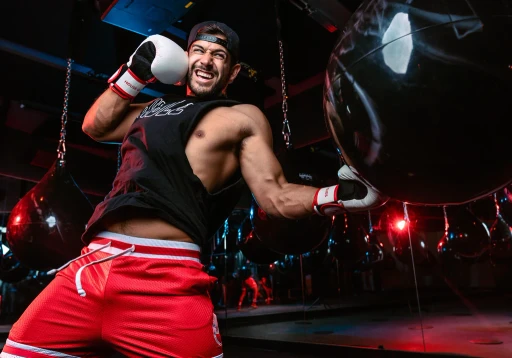 Blurred portrait of a person in an orange patterned shirt with glowing glasses, creating a futuristic and artistic vibe.