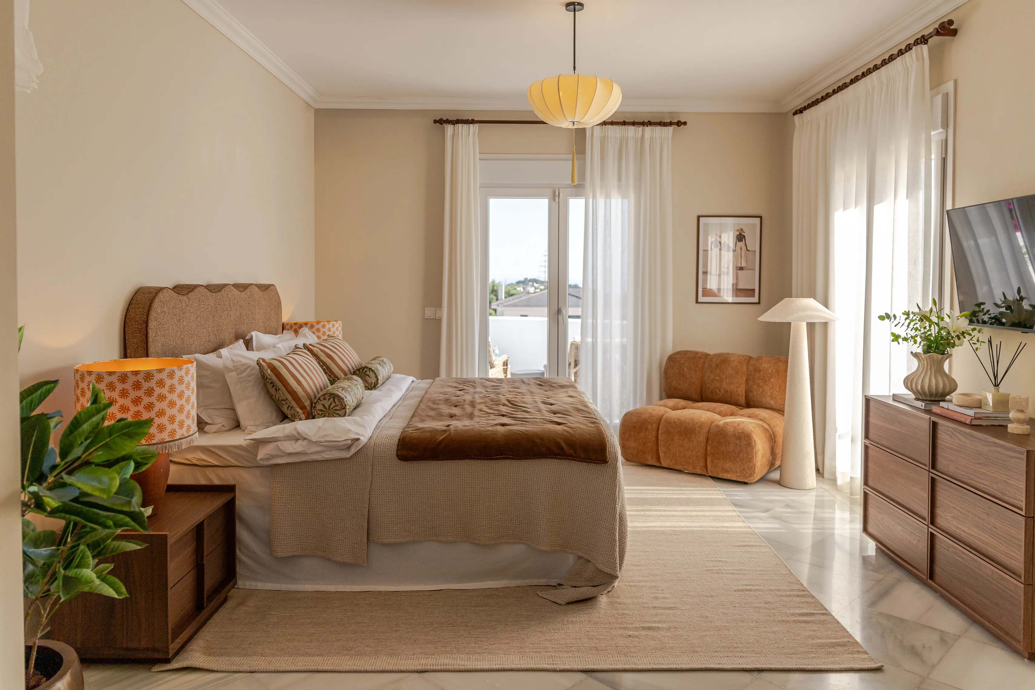 Contemporary bedroom with bespoke furnishings, soft natural tones and abundant daylight.