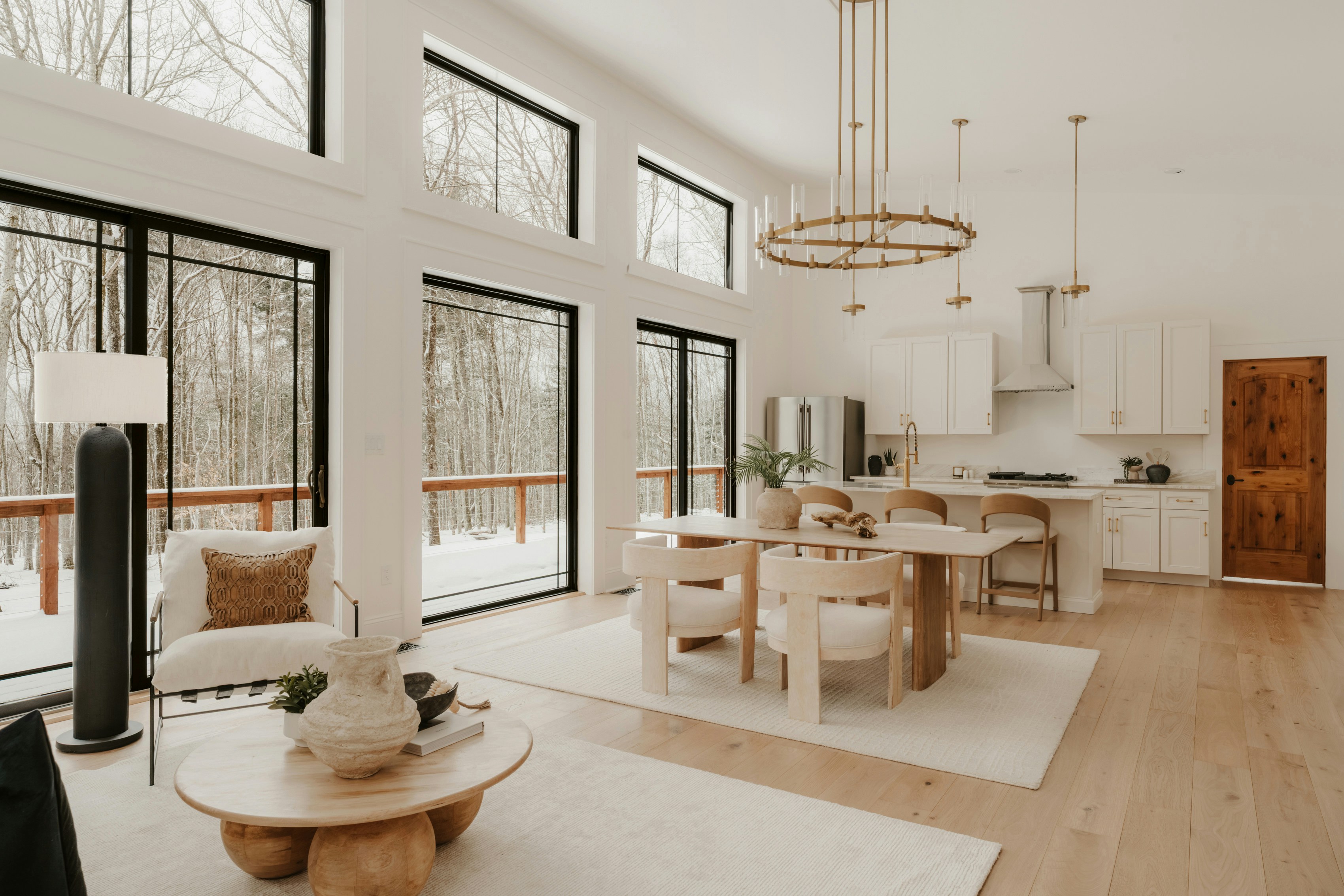 Modern living room with large windows overlooking winter forest