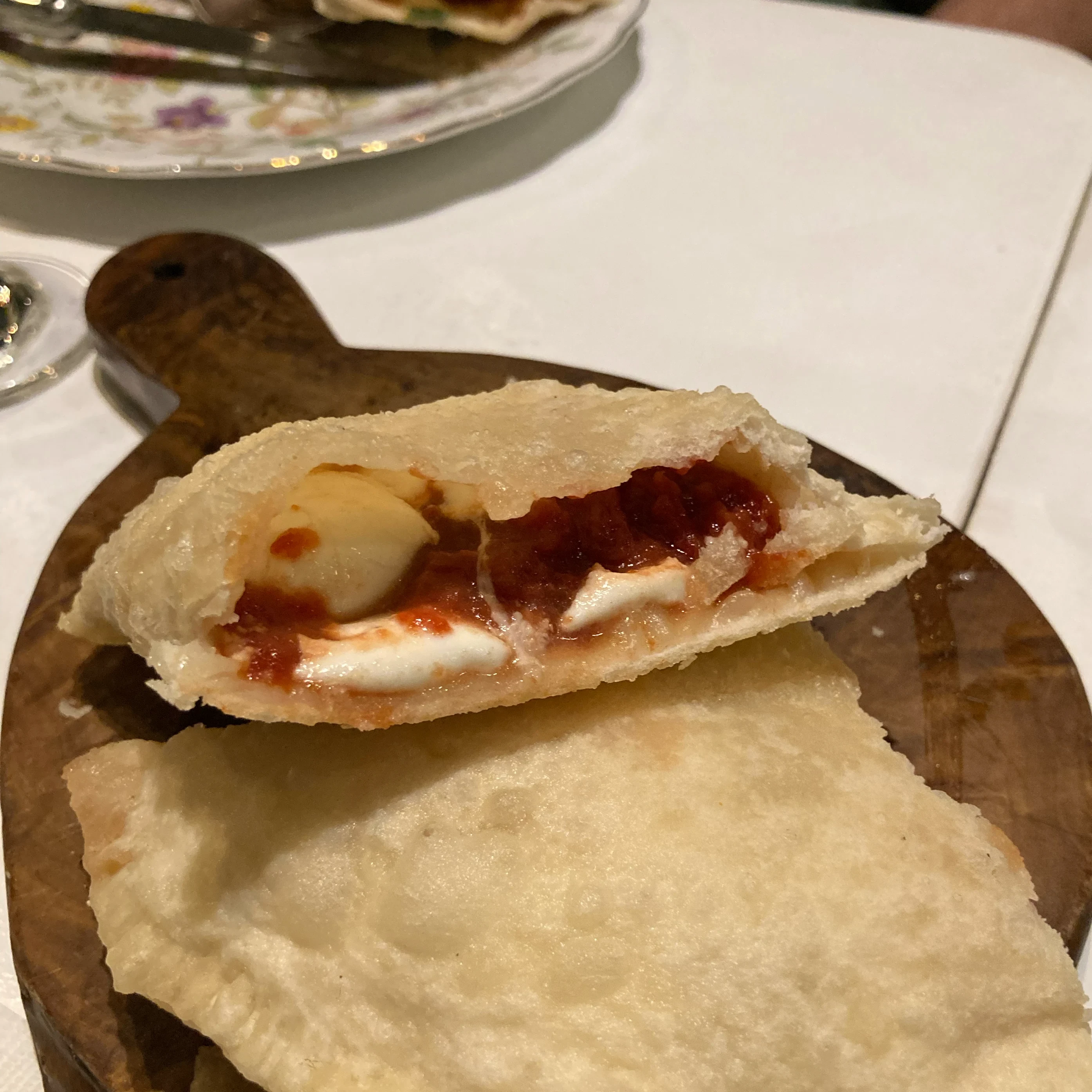 a panzerotti with mozzarella cheese and tomato