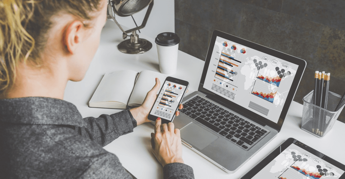 Woman analyzes business charts on devices - Social Media Content Ideas