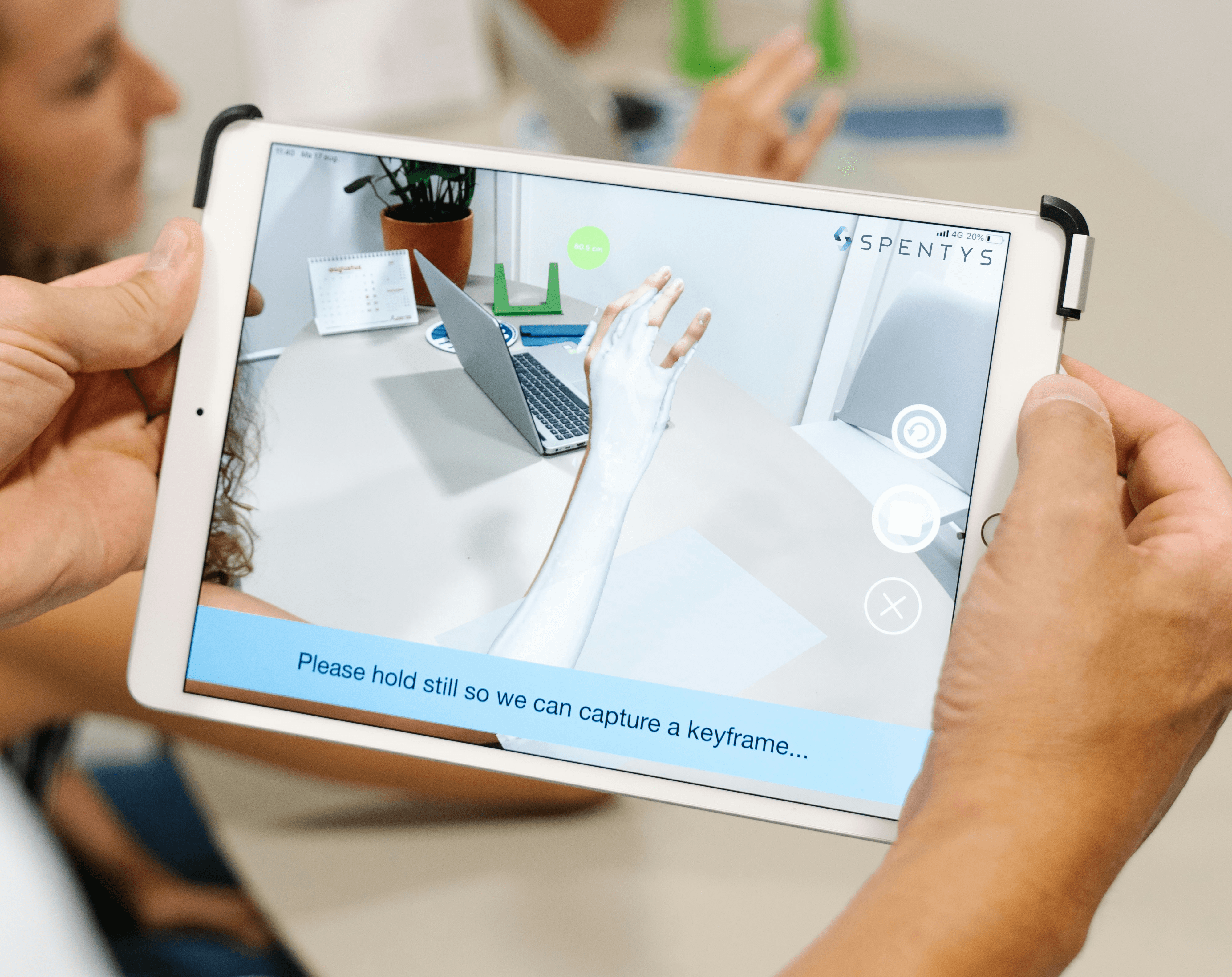 person holding white ipad mini