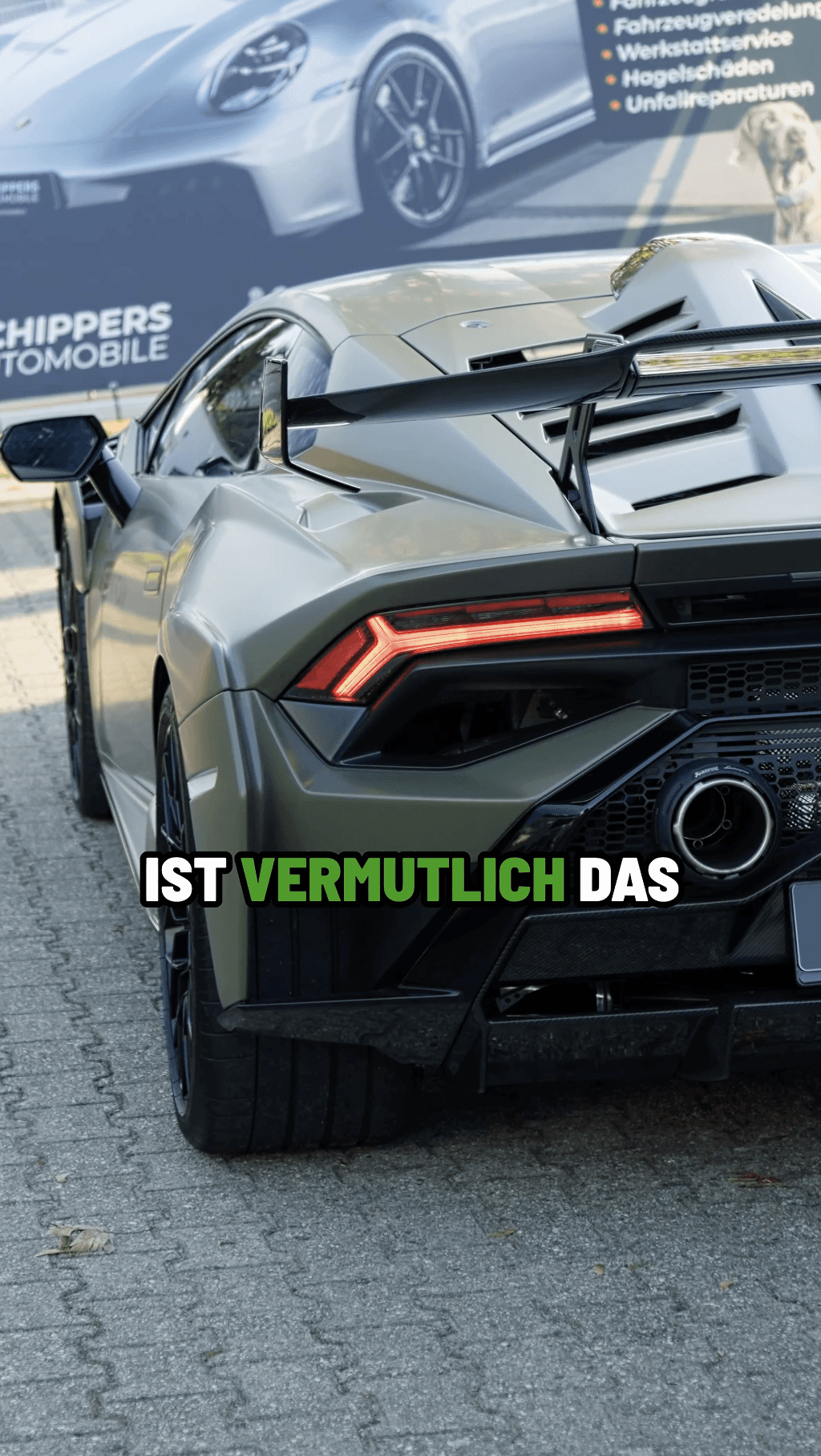 Contemporary estate with wooden accents, large windows and landscaped garden in warm evening light.