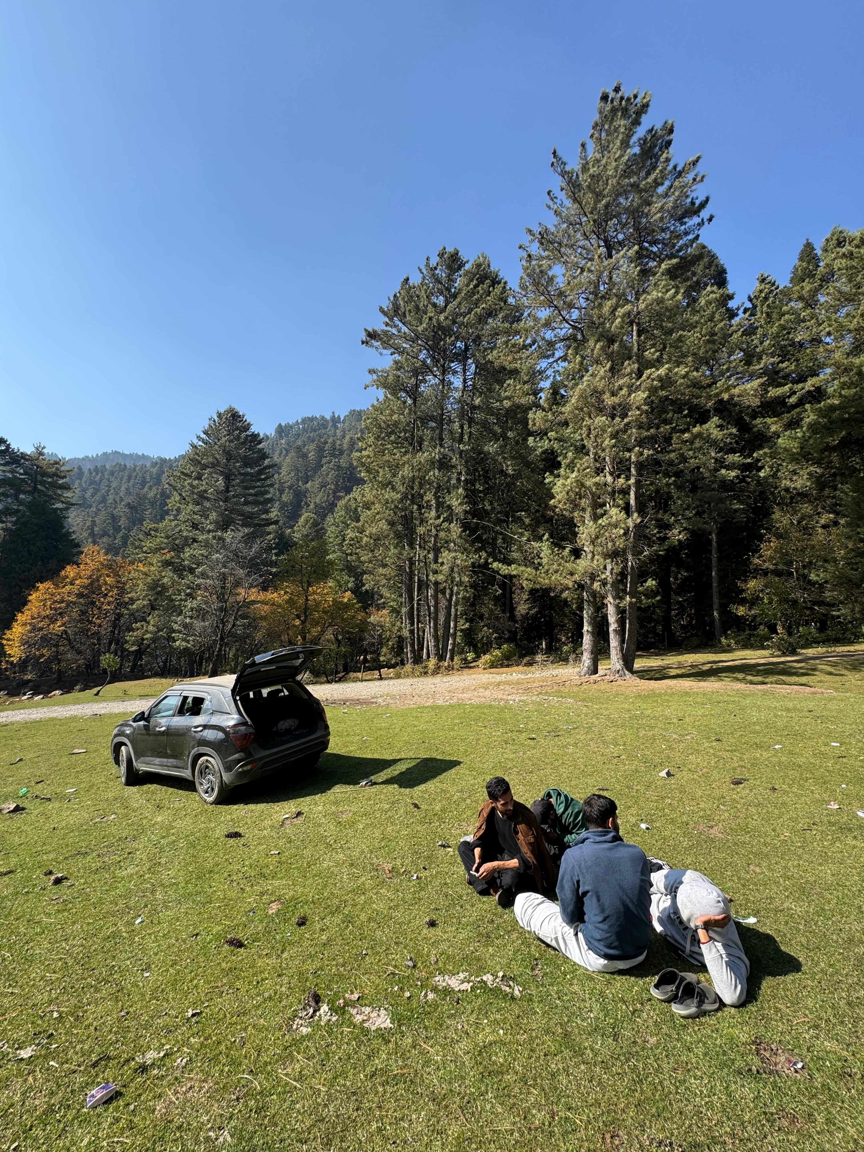 A man stading with Surfboard