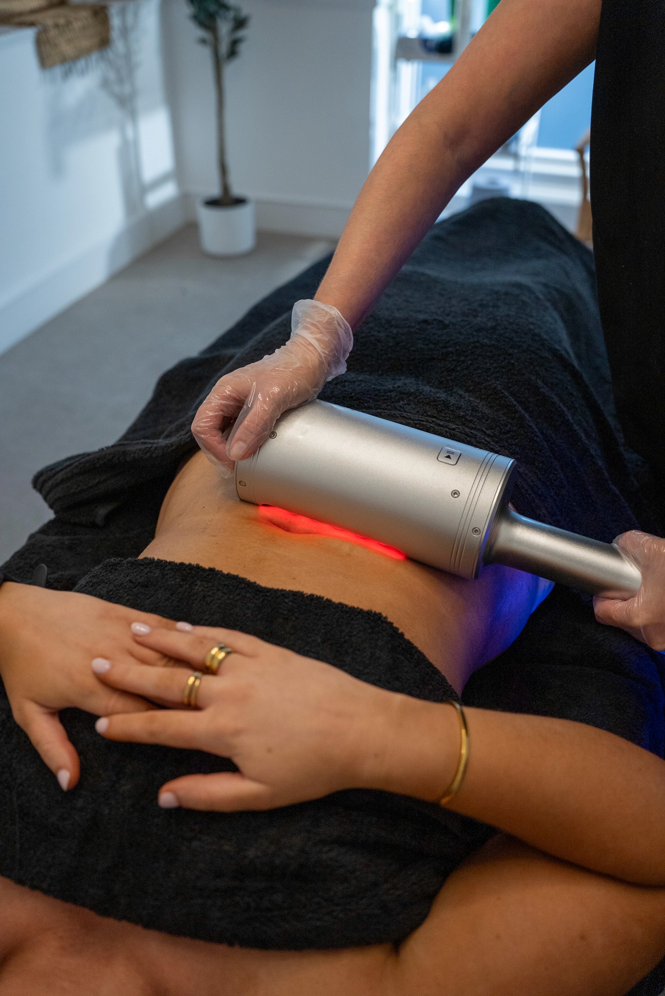 Body treatment with red light therapy device.