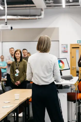 People working in a classroom with computers.