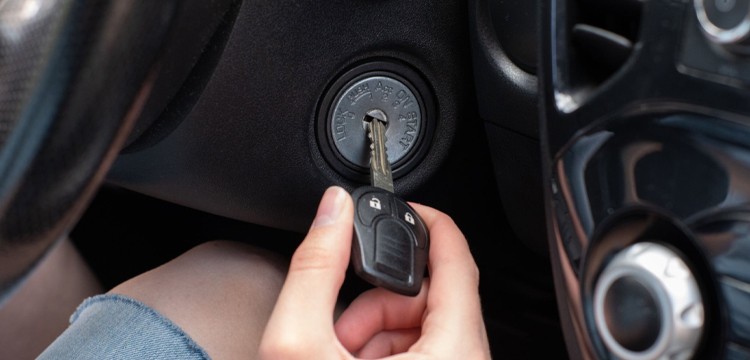 person inserting remote key in the ignition