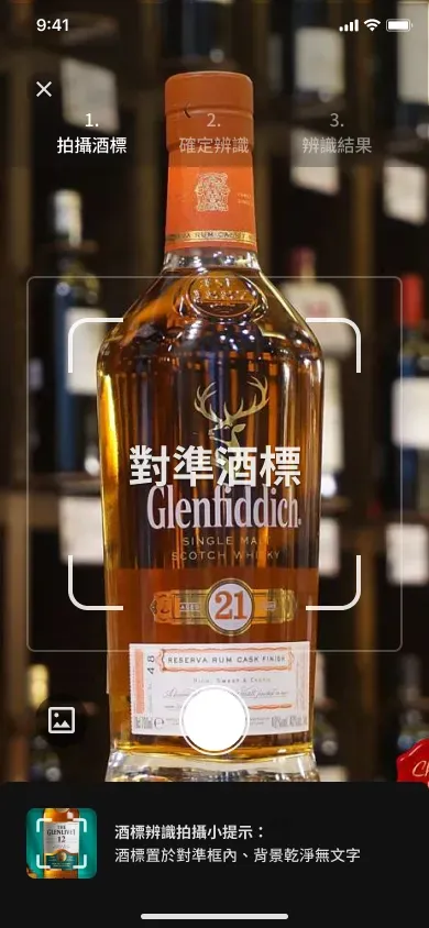 Redesigned whisky label scanning screen with step indicator and bottom tip bar, showing Glenfiddich 21 aligned in the camera viewfinder