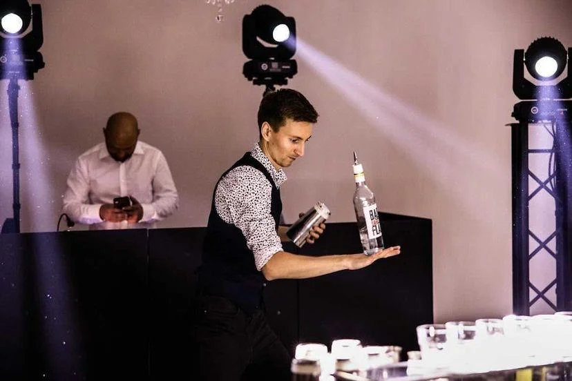 Drink bar na weselu z barmanem zachwycającym gości podczas pokazu.