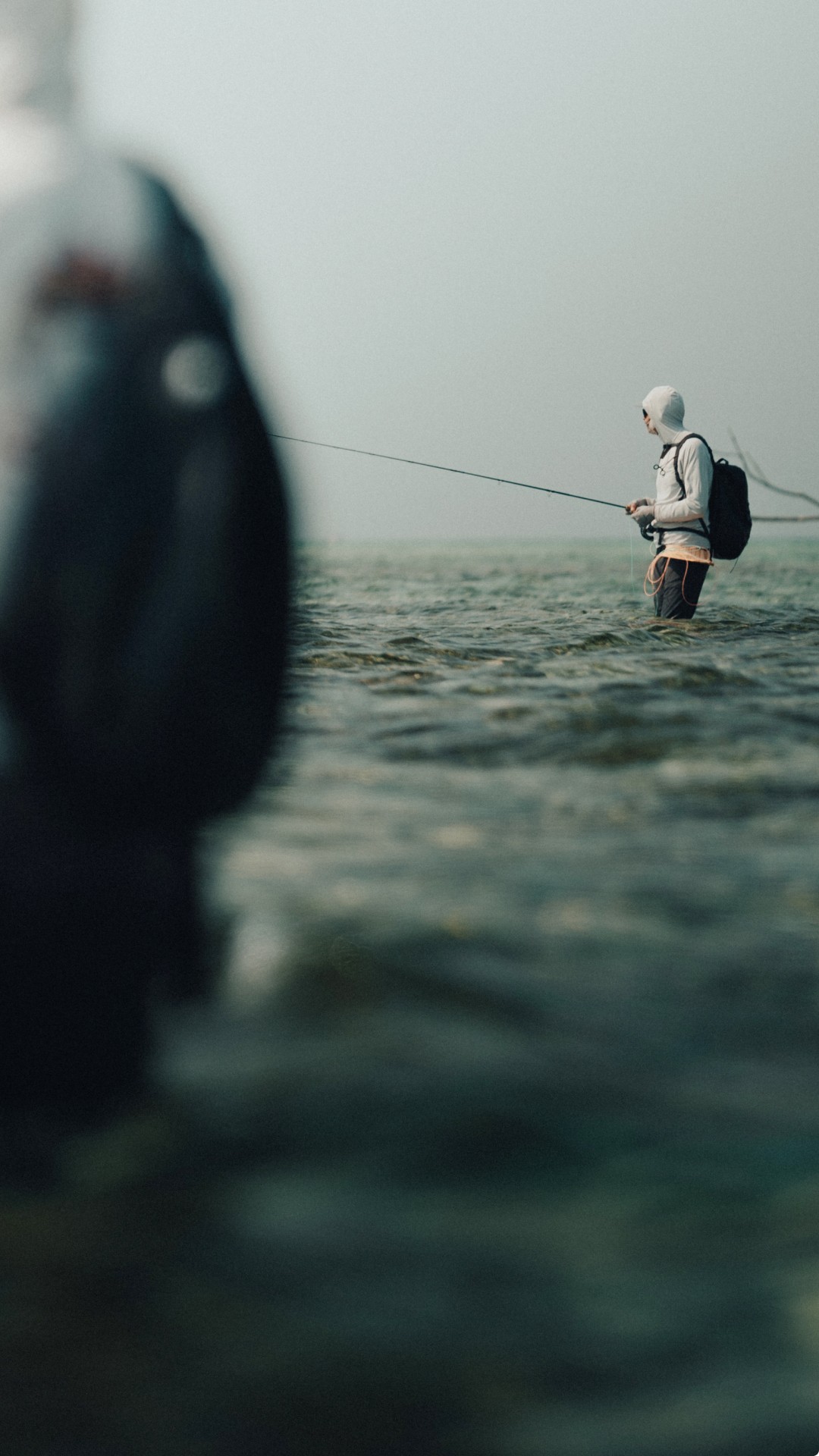 Two anglers vading shallow flats flats looking for permit and bonefish