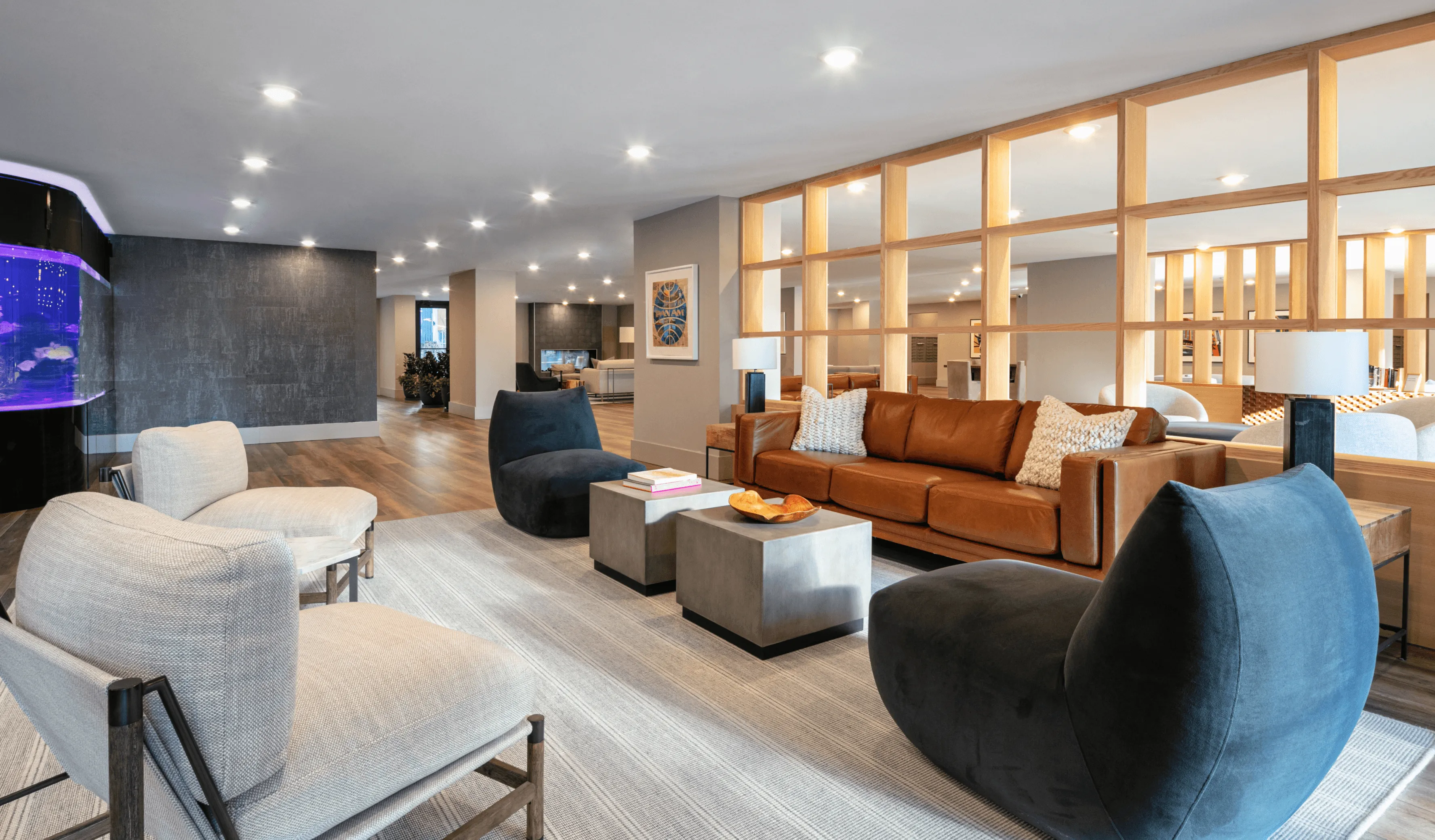 Modern living room with stylish furniture, warm lighting, and a cozy atmosphere, featuring a large TV and decorative elements.