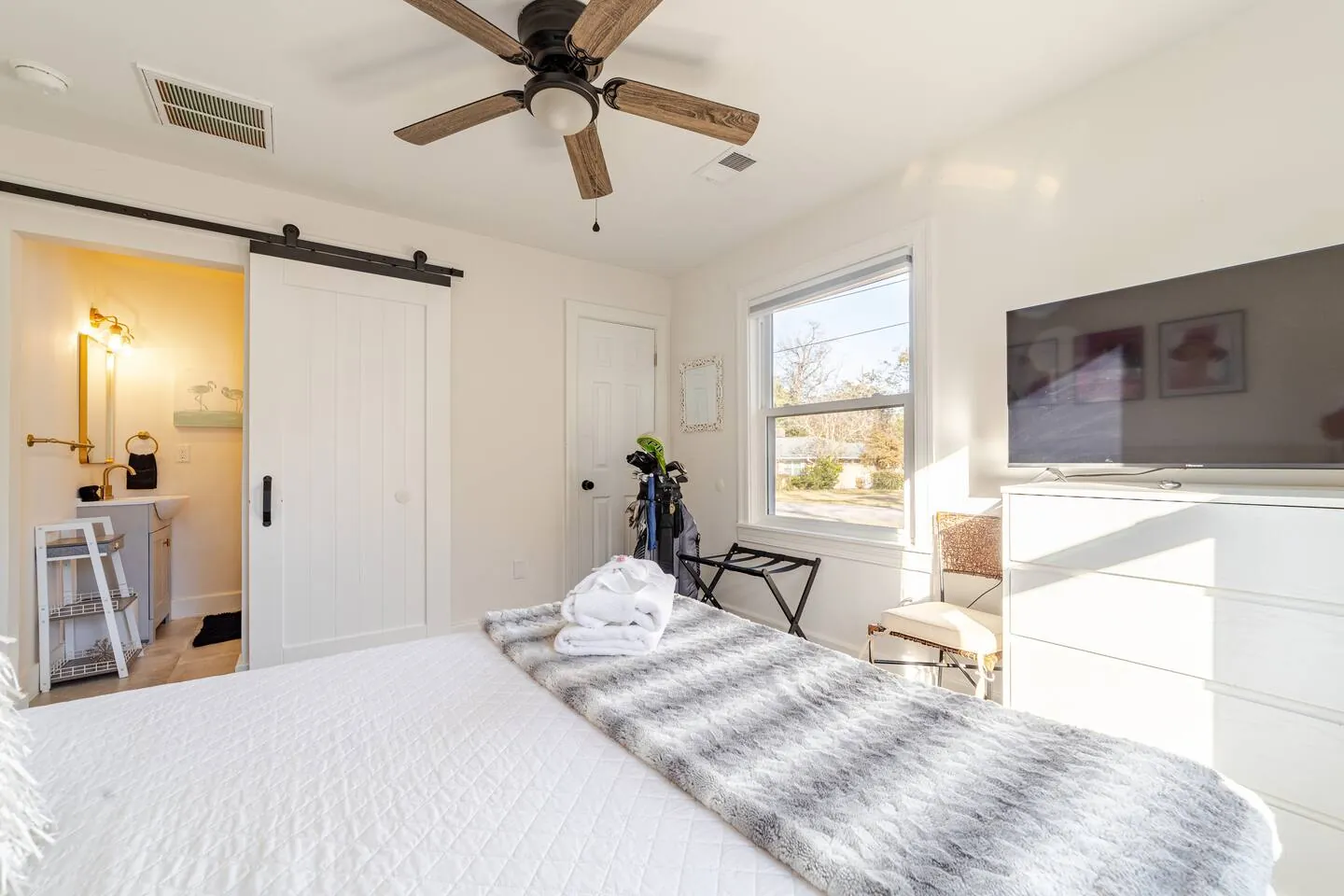 Queen bedroom with a sliding barn door to its en-suite bathroom