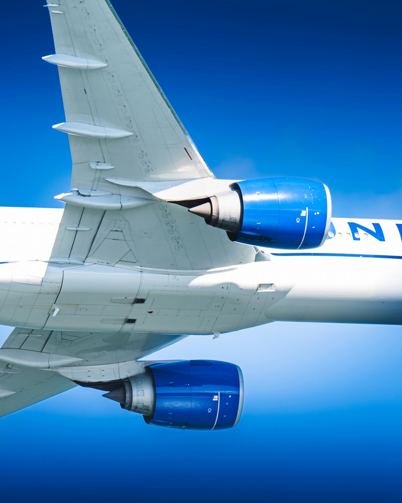 Airplane engines and tail against a blue sky