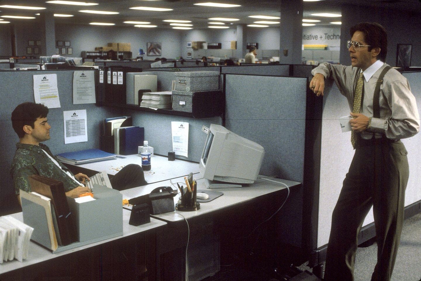 The image features a futuristic humanoid figure with a smooth, white surface, wearing a helmet with an orange visor that emits a soft glow. 