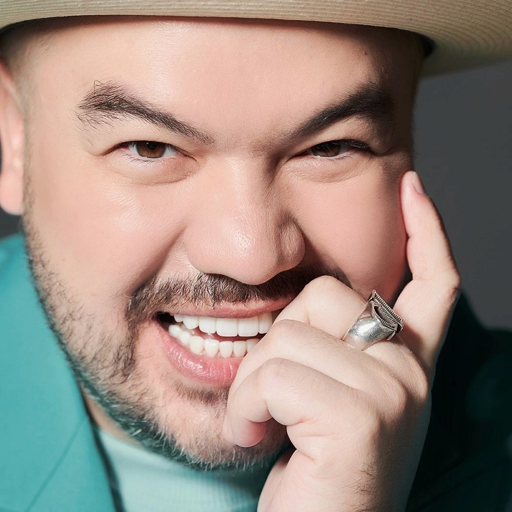 Man in a cap smiling after ceramic veneer treatment at COSDENT