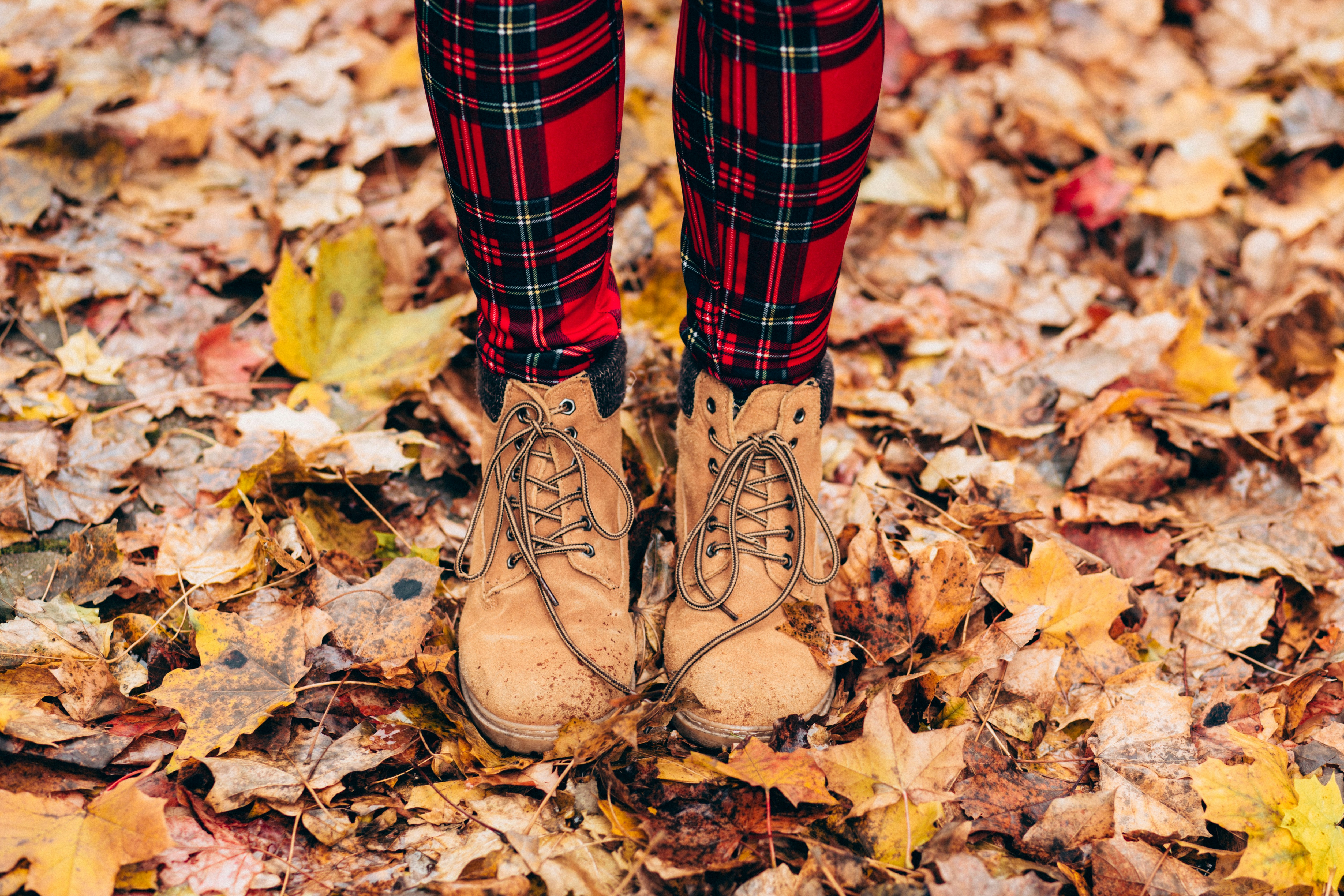 Person with Boots Standing on Fall Leaves - Plus Size Fall Outfits