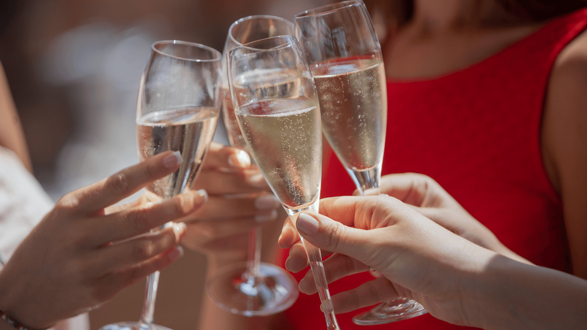 People clinking champagne glasses together