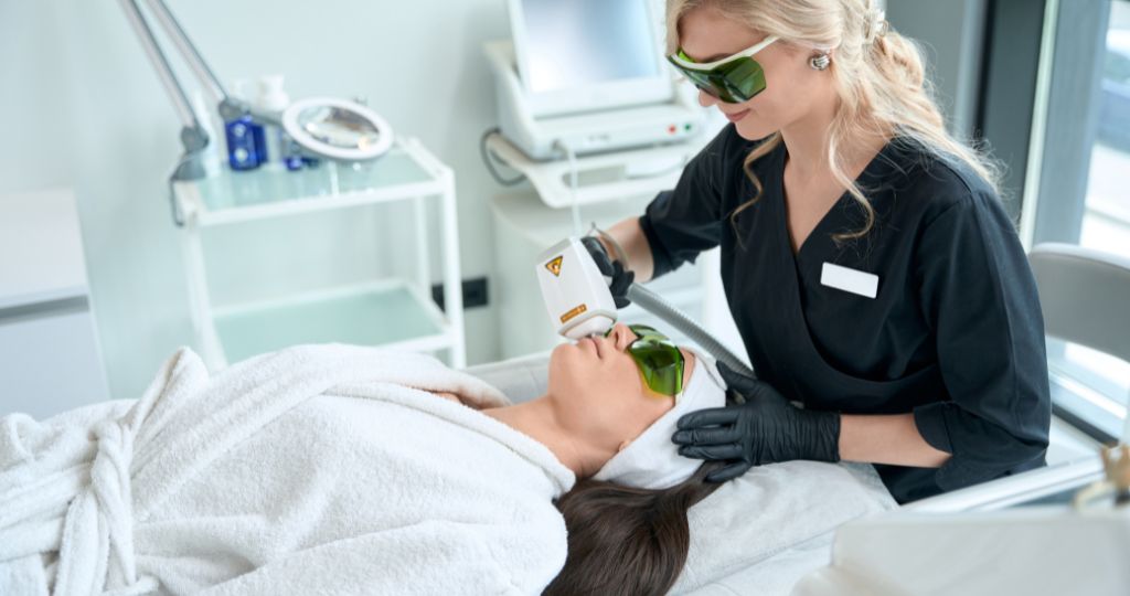 Laser cosmetic clinic professional performing facial treatment on a client