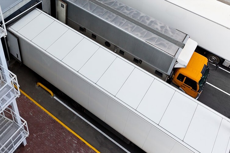 Freight trucks parked at a loading dock