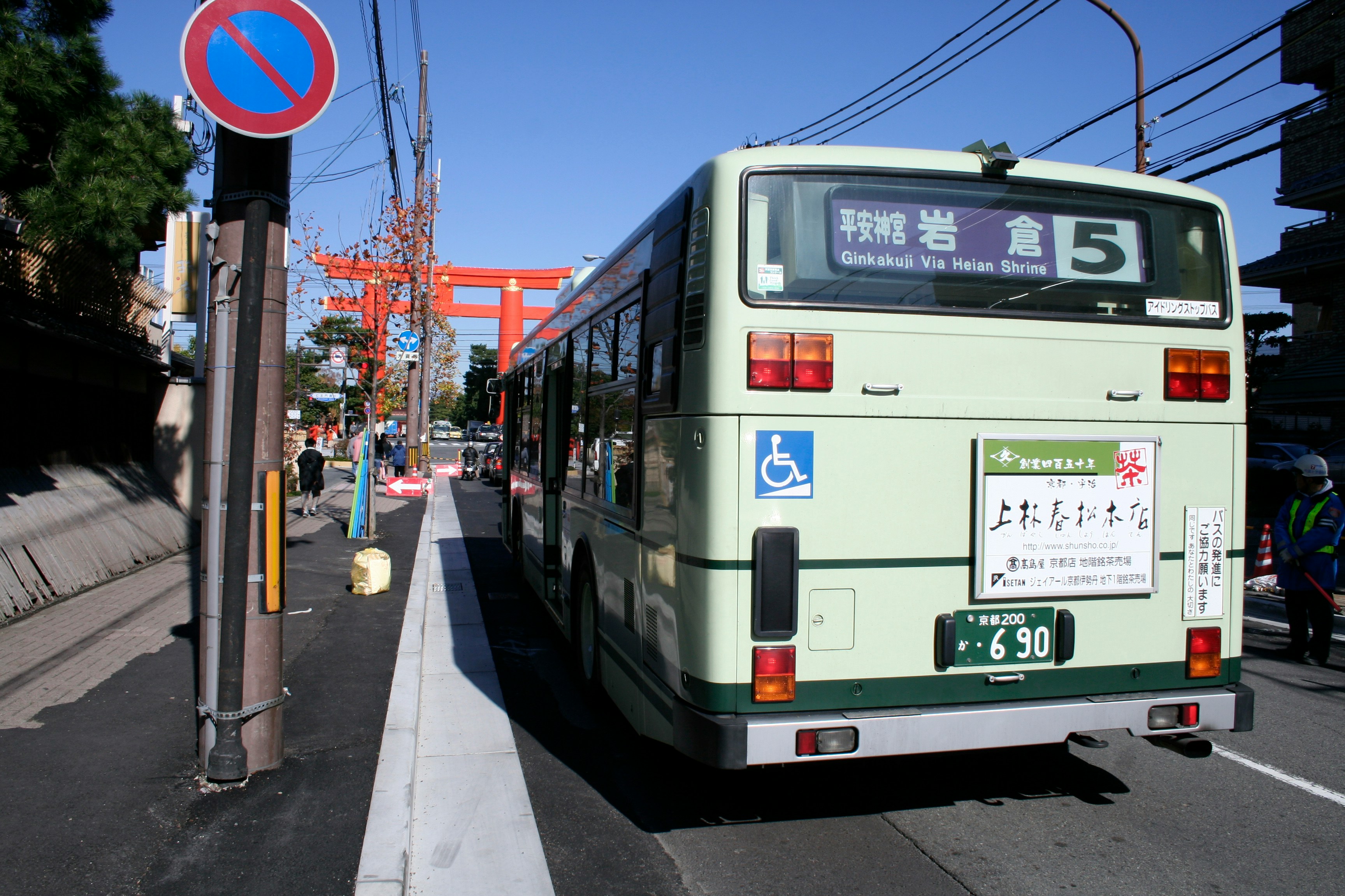 A green bus driving down a city street