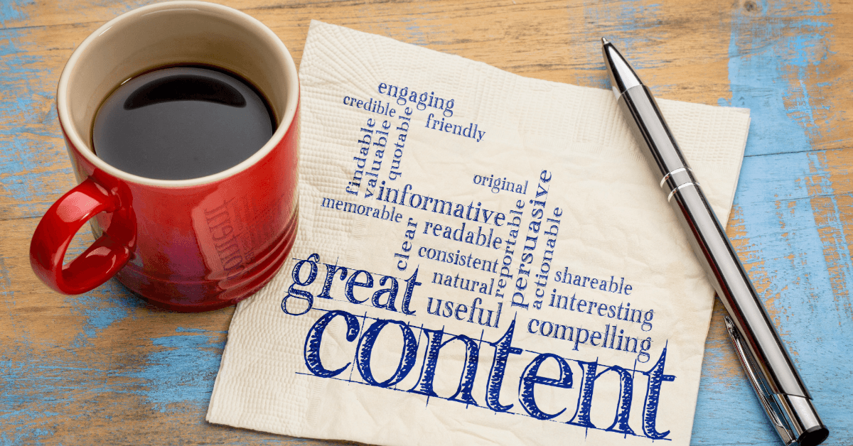 cup of coffee sitting on a table with a pen and napkin which has words on it