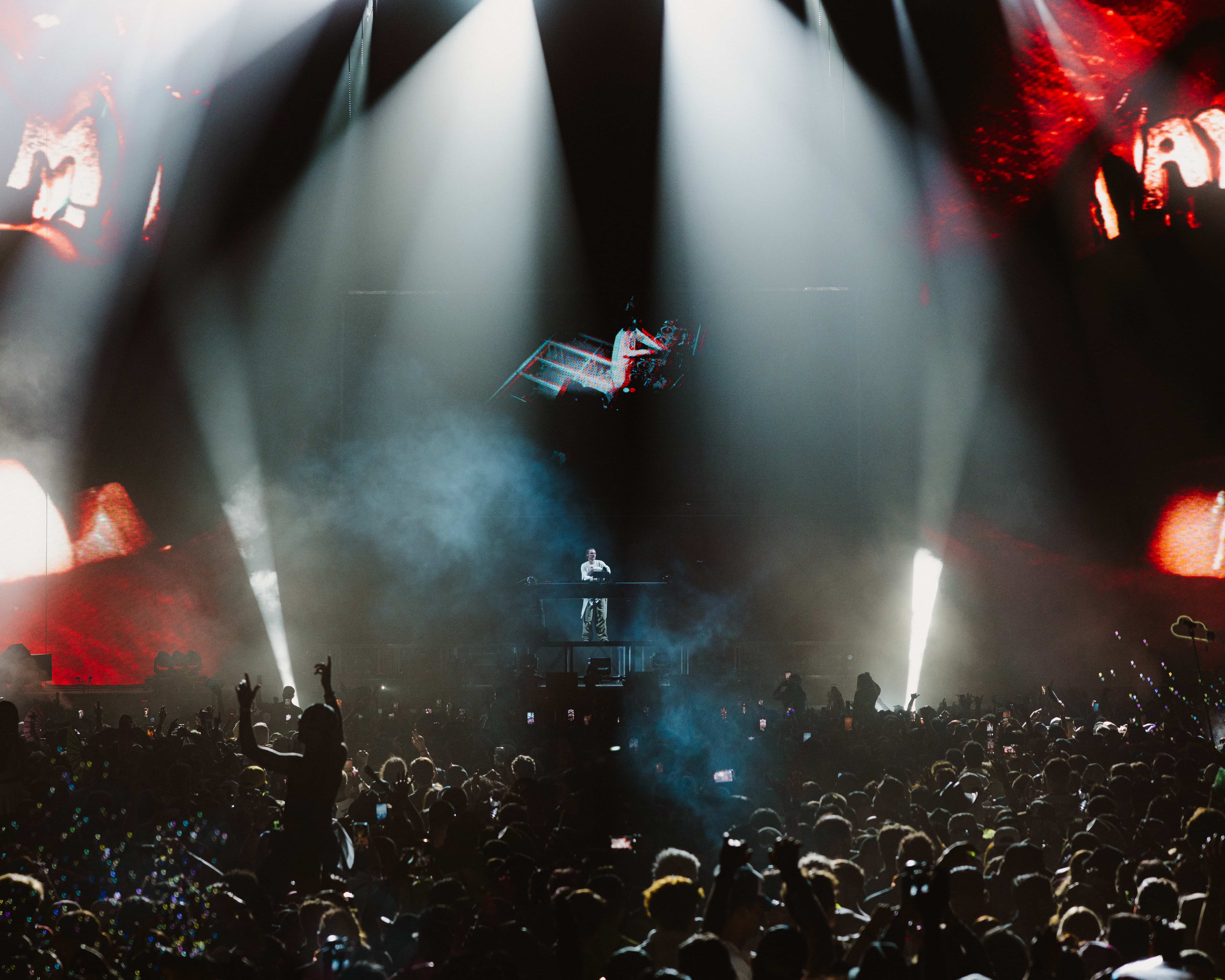 MAU P performing live at Coachella 2025 on an elevated stage with dramatic lighting and a packed crowd below, captured by A World Away creative director Brandon Densley