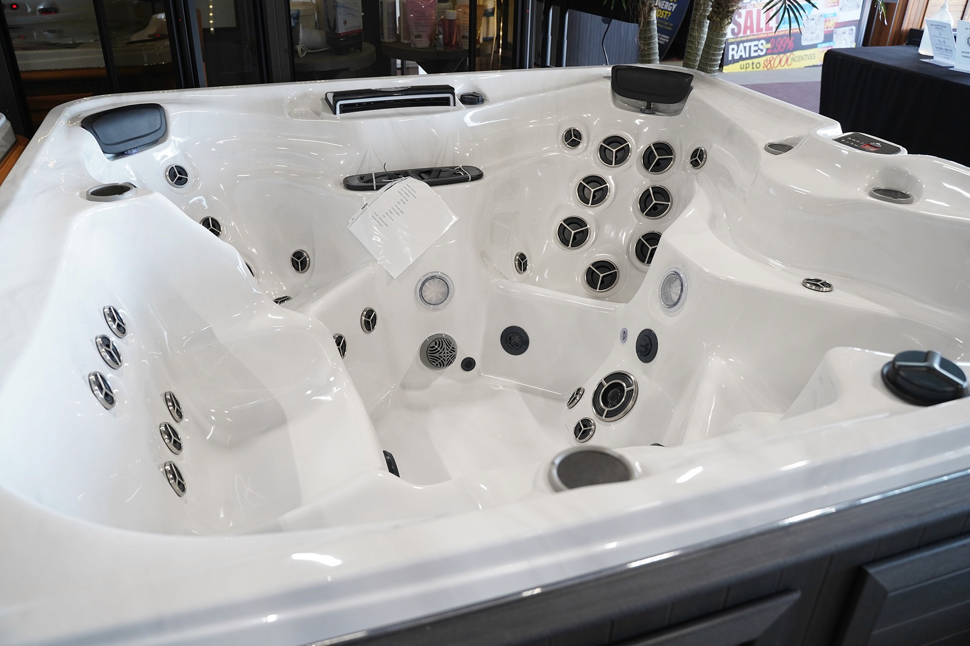 a wide image of a brand new hottub in a showroom