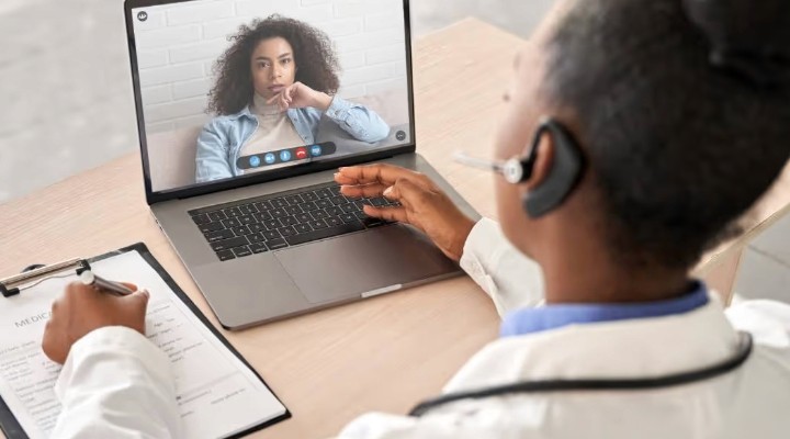 Woman on a telehealth video call.