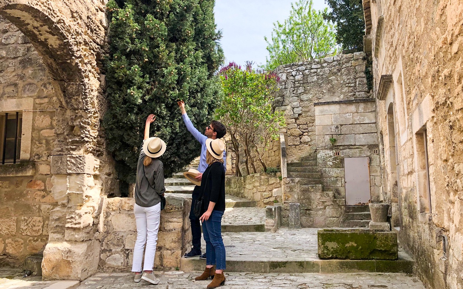 Tourists exploring historic stone architecture in Provence.