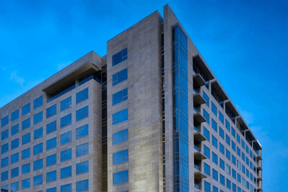 A black and white city scene with a bus.