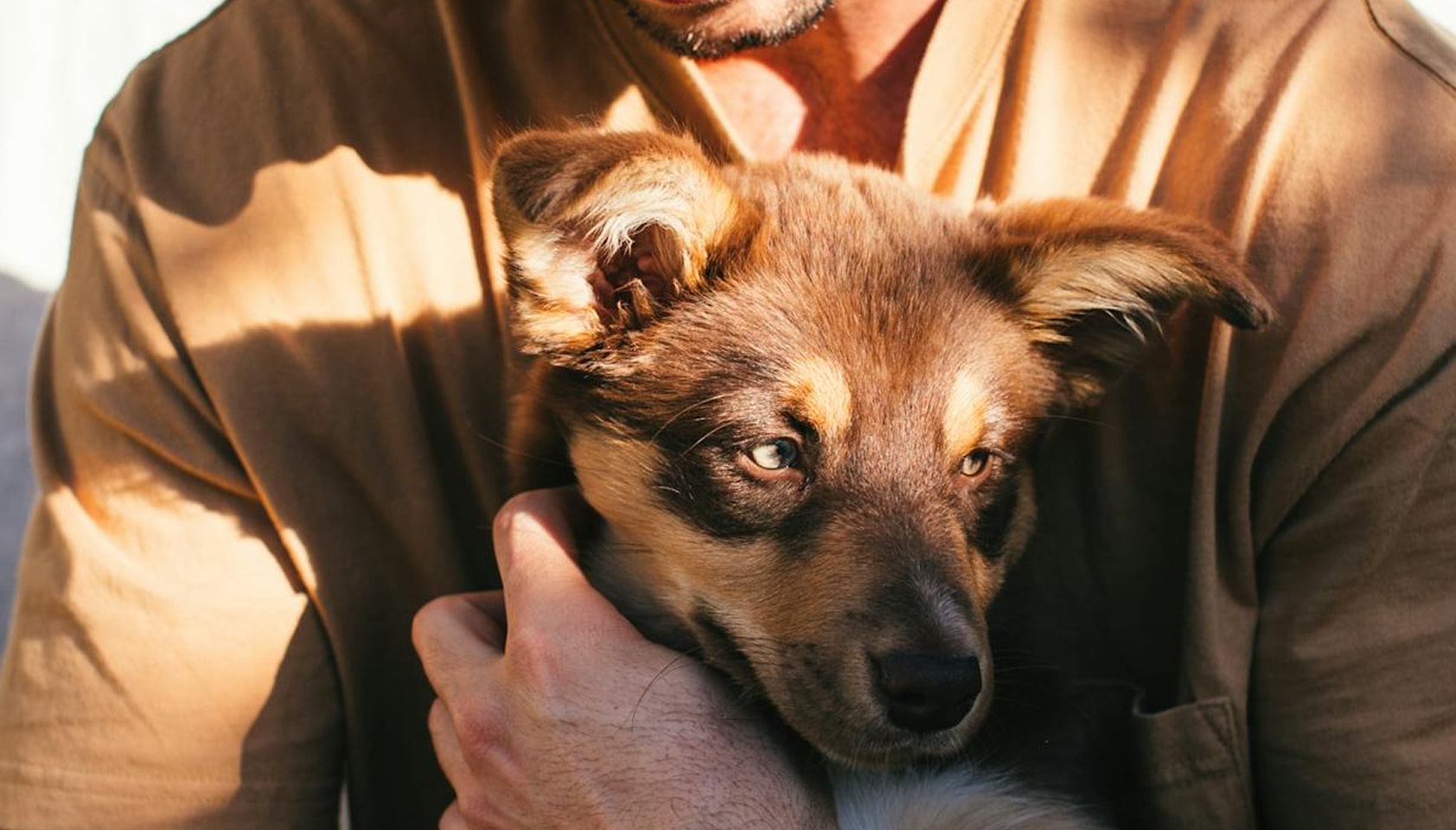 man holding a puppy
