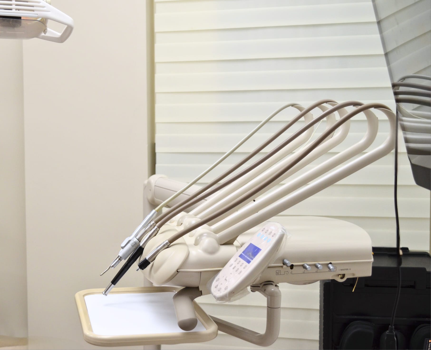  close-up view of a dental chair with various dental instruments attached, ready for a cosmetic dentistry procedure.