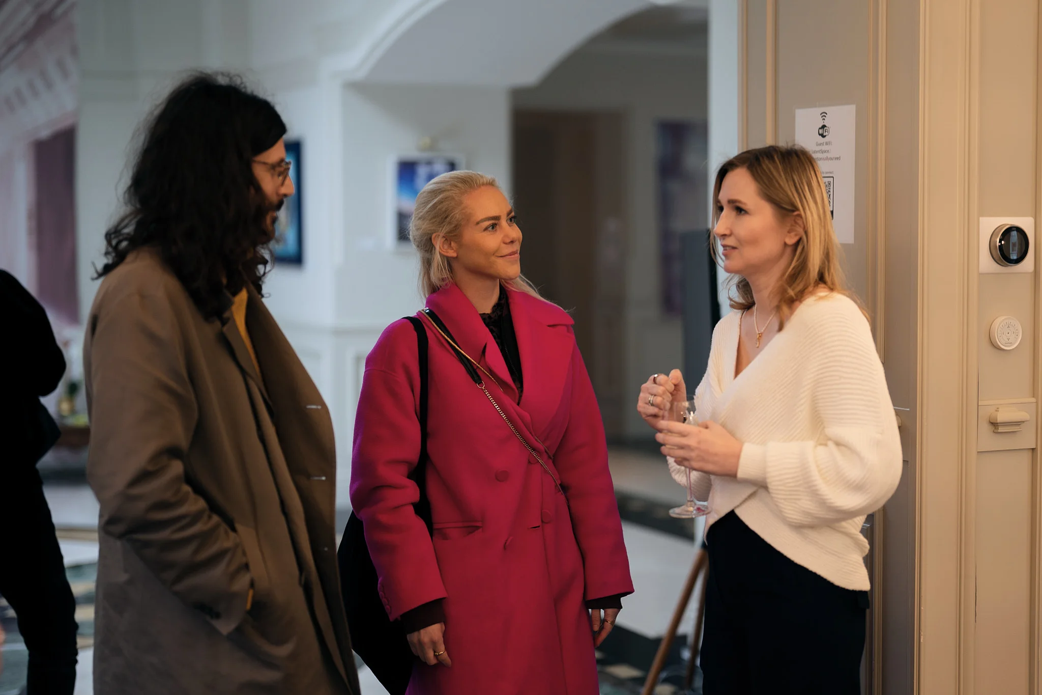 Candid group conversation with drinks at an invite-only DVC LP & partners event in San Francisco (modern corporate event photography).