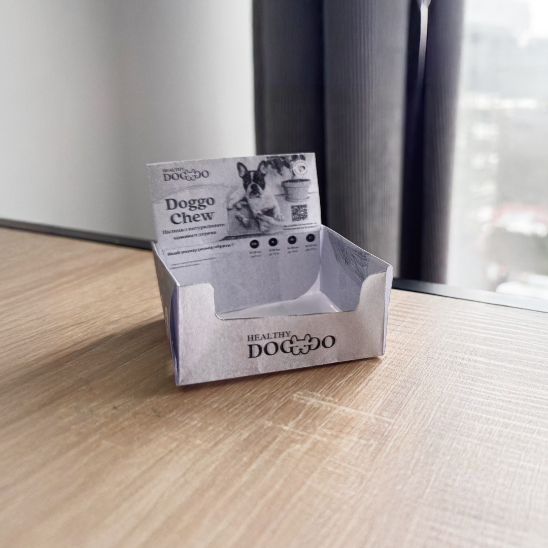 Modern home office setup with a monitor, ergonomic chair, keyboard, and indoor plants near a window with blinds.