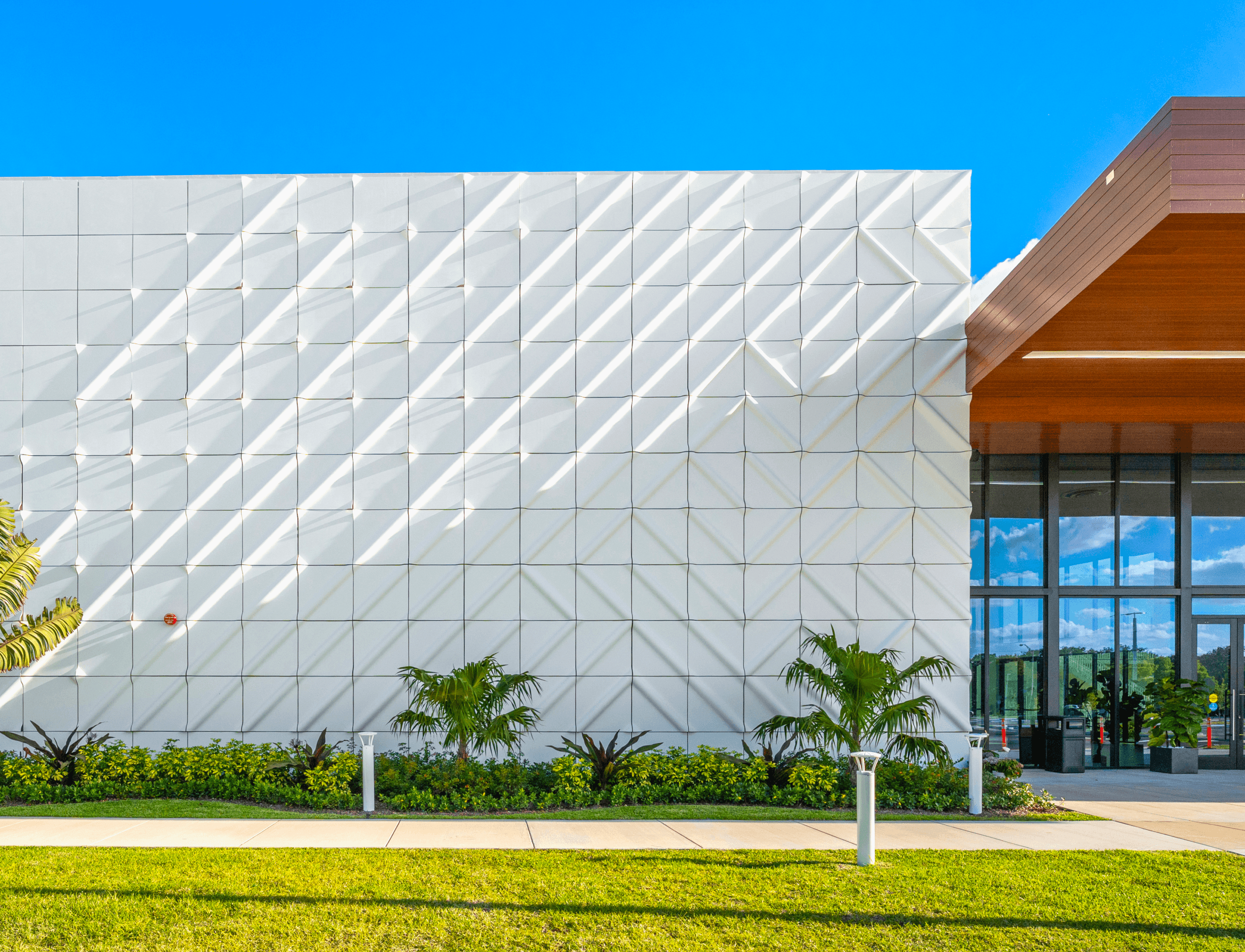Exterior facade of a church made out of a grid of panels that were curved to show a pipe-like pattern at scale.