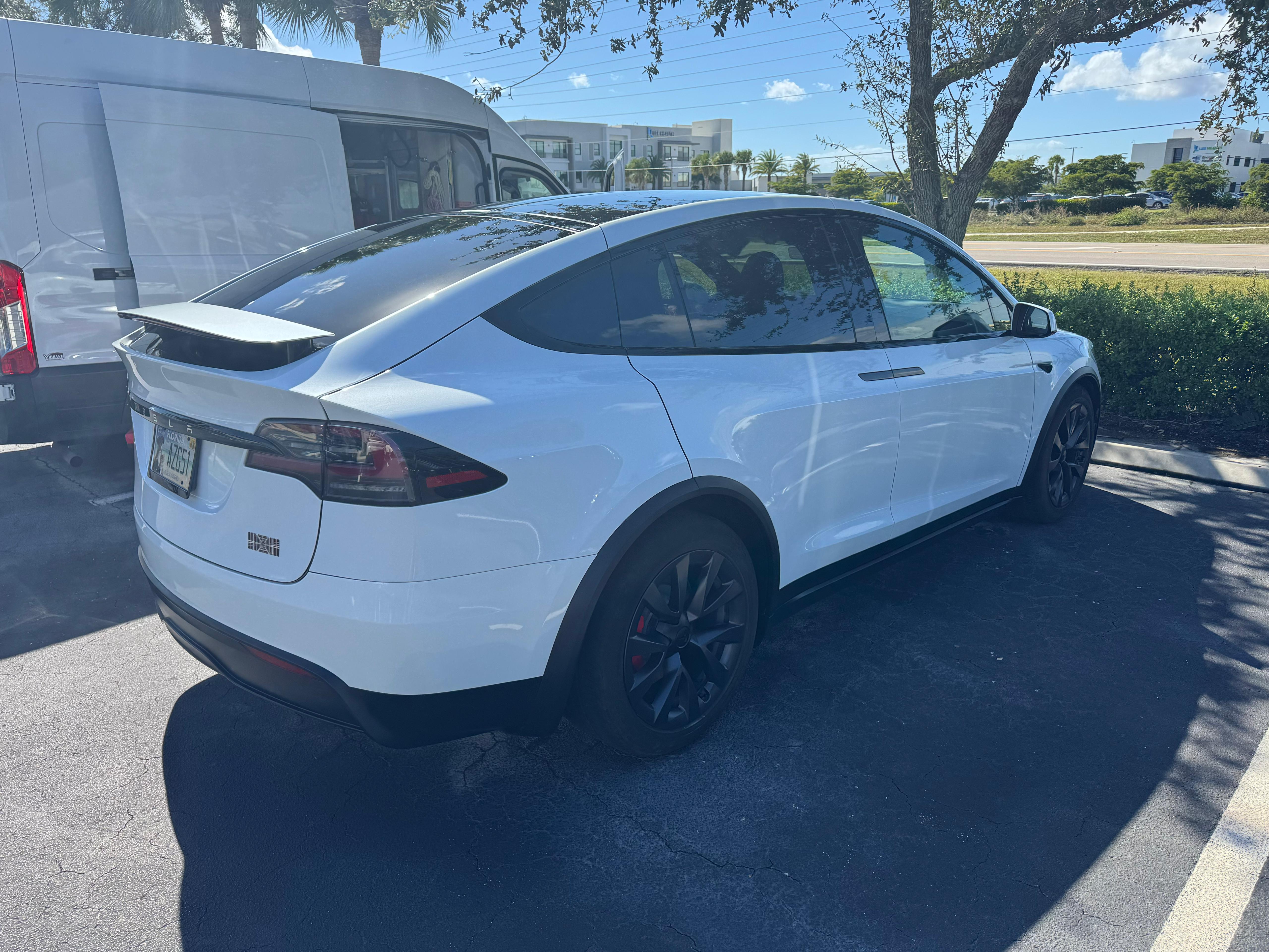 Clean and polished Tesla Model X Plaid after Platinum Detail with high-gloss ceramic finish under Florida sunlight