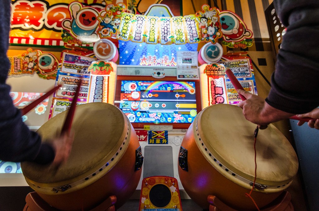 A drum arcade game played by two people with drumsticks