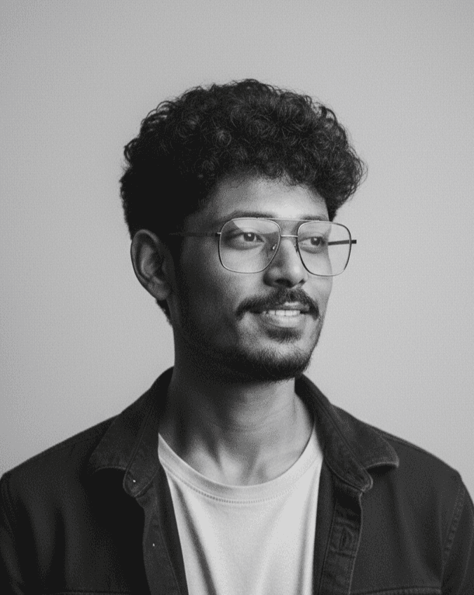 Portrait of a woman with long, smooth hair swept to the side, in a dark t-shirt, on a plain background.