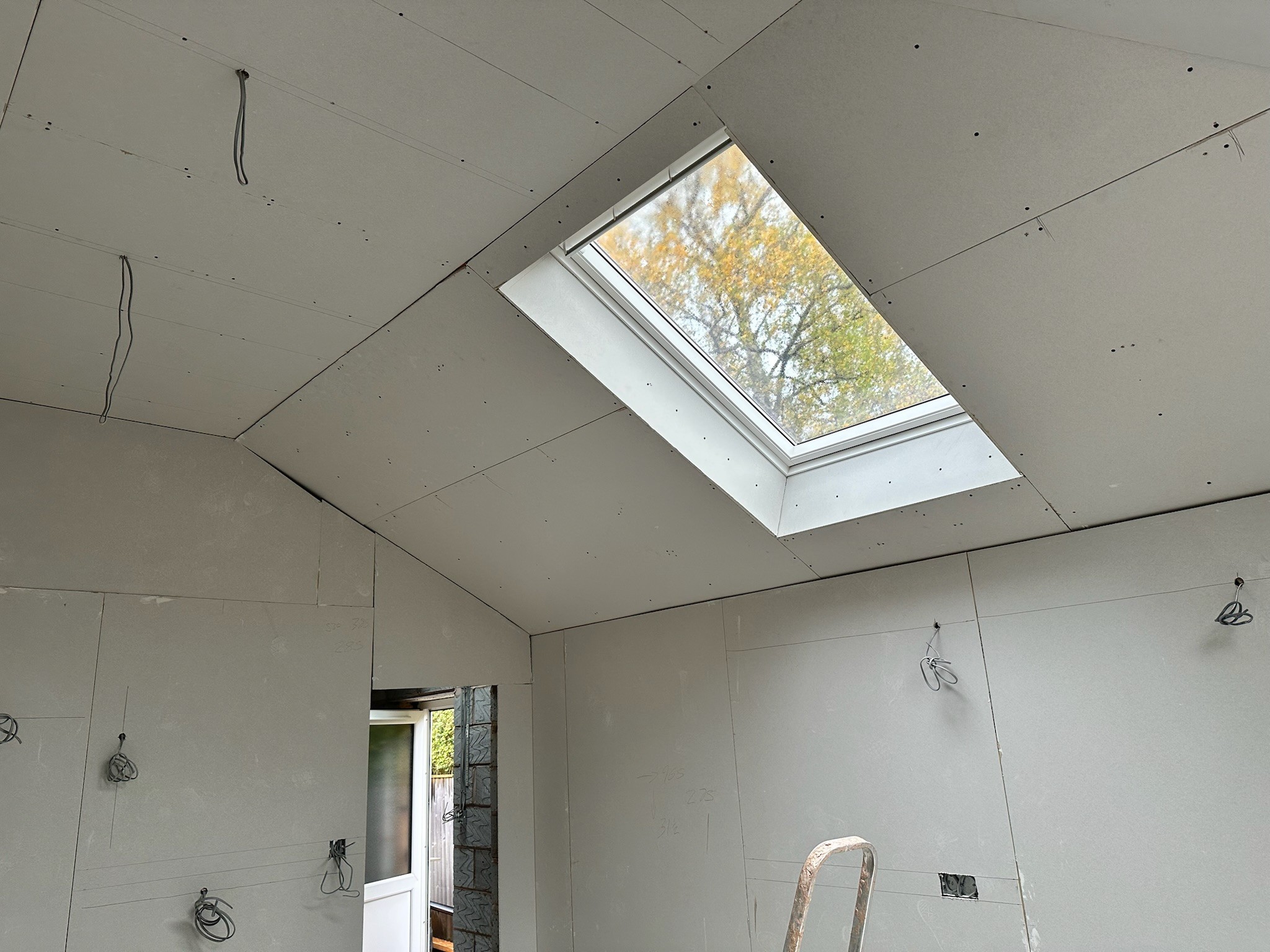 Boarded ceiling, walls and Velux windows.
