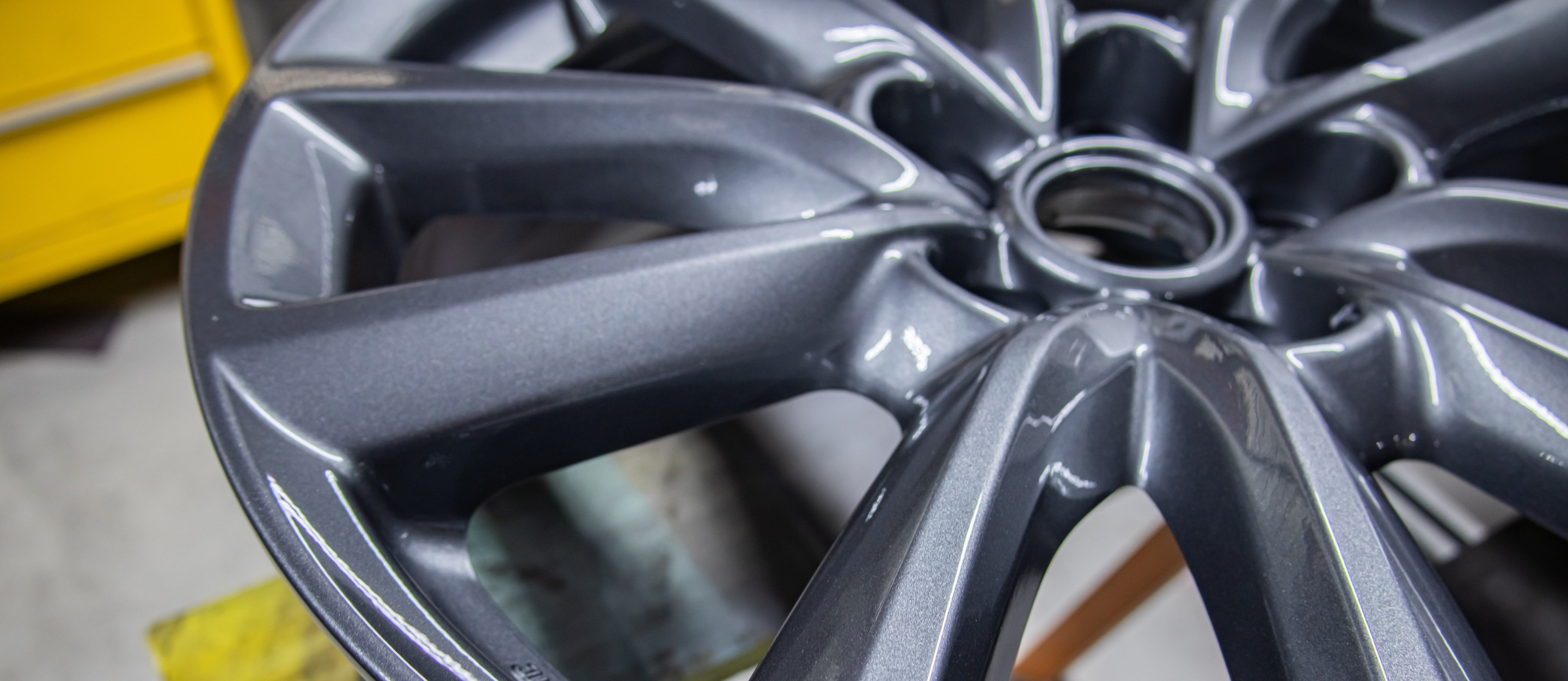 Dark gray car wheel with metallic finish